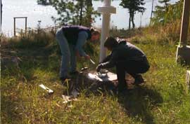 Two people repairing flagpole