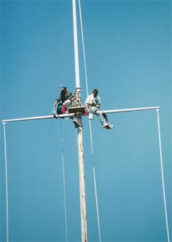 People repairing flagpole